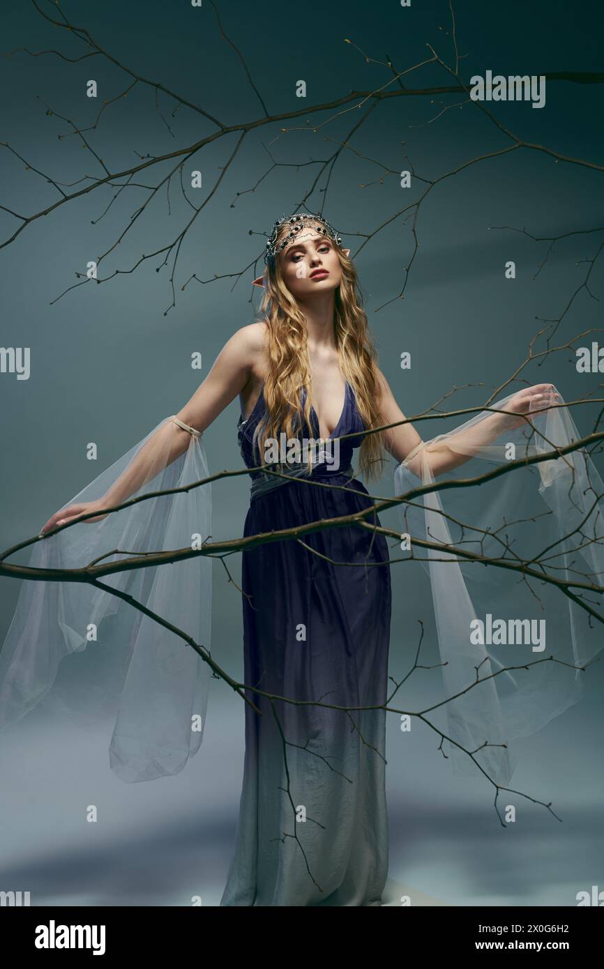 A young woman in a blue dress stands gracefully in front of a sprawling ...