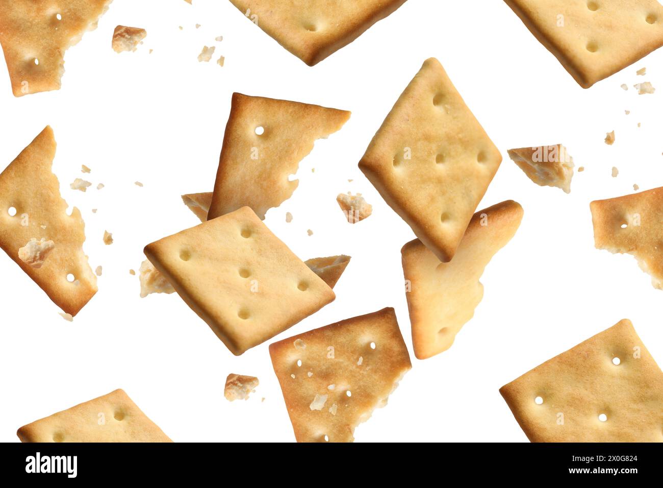 Tasty dry crackers falling on white background Stock Photo