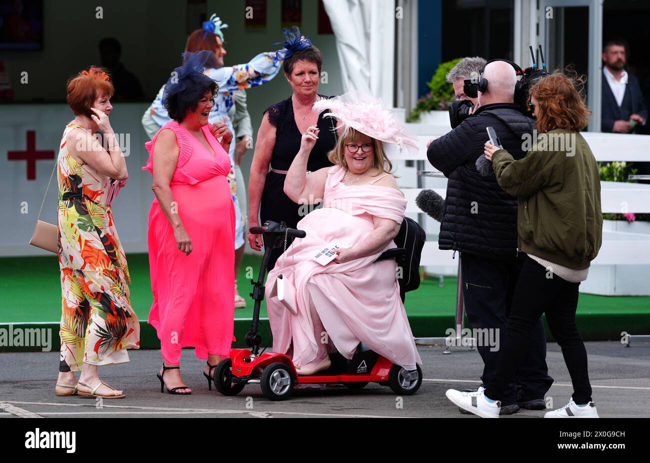 Racegoers on day two of the 2024 Randox Grand National Festival at Aintree Racecourse, Liverpool. Picture date: Friday April 12, 2024. Stock Photo