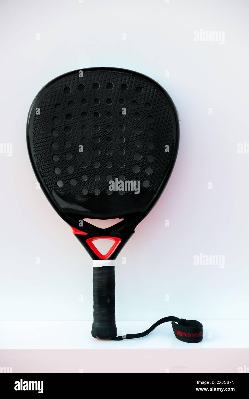 Black professional Padel tennis racket on white background. vertical sport theme poster, greeting cards, website and app Stock Photo