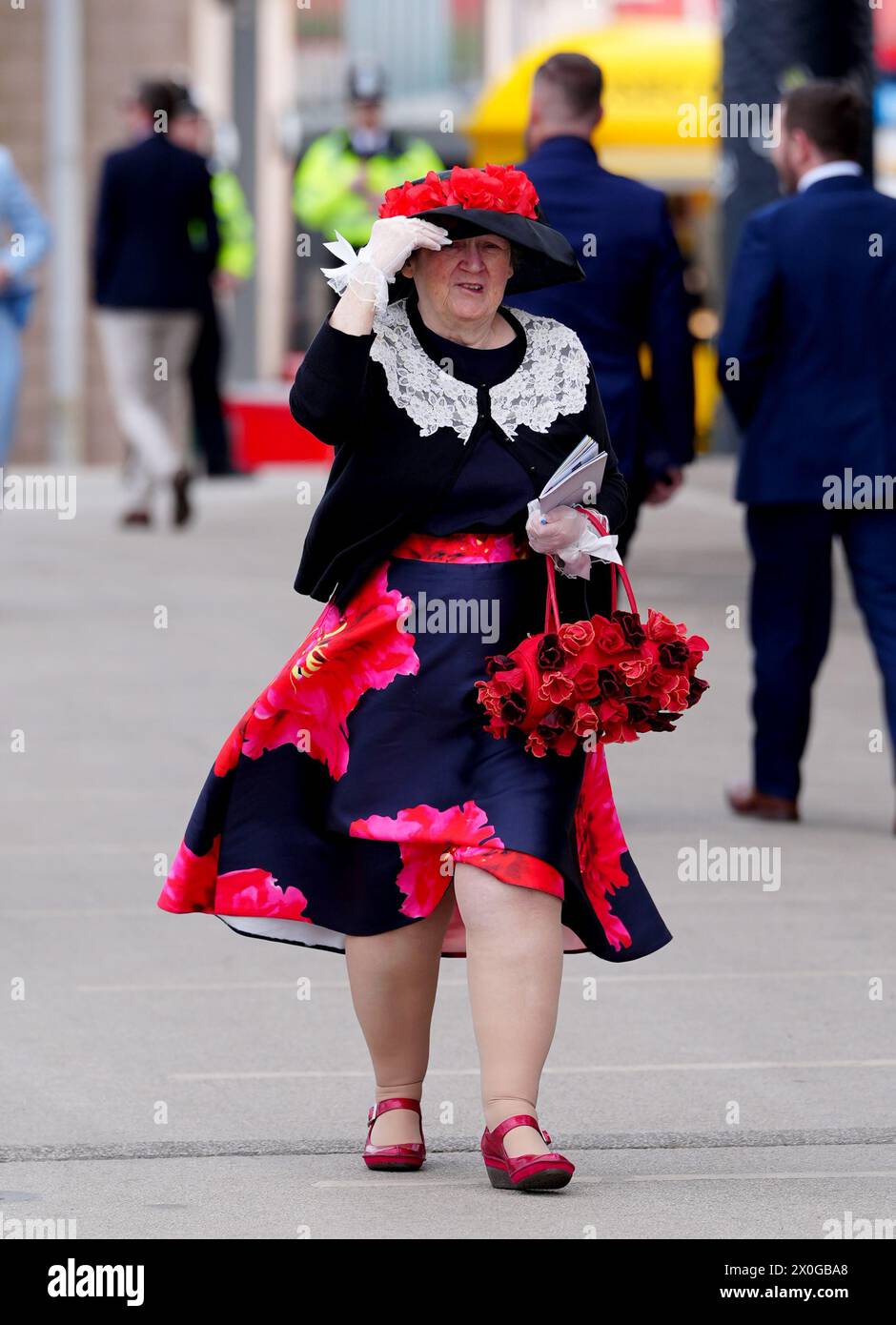 A racegoer on day two of the 2024 Randox Grand National Festival at Aintree Racecourse, Liverpool. Picture date: Friday April 12, 2024. Stock Photo