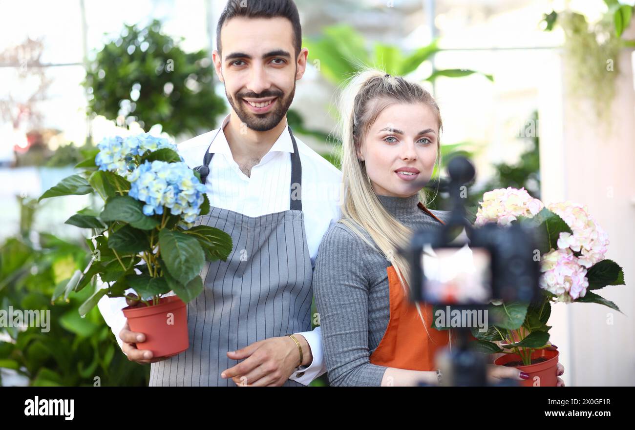 Man and Woman Recording Flower Vlog to Camera Stock Photo