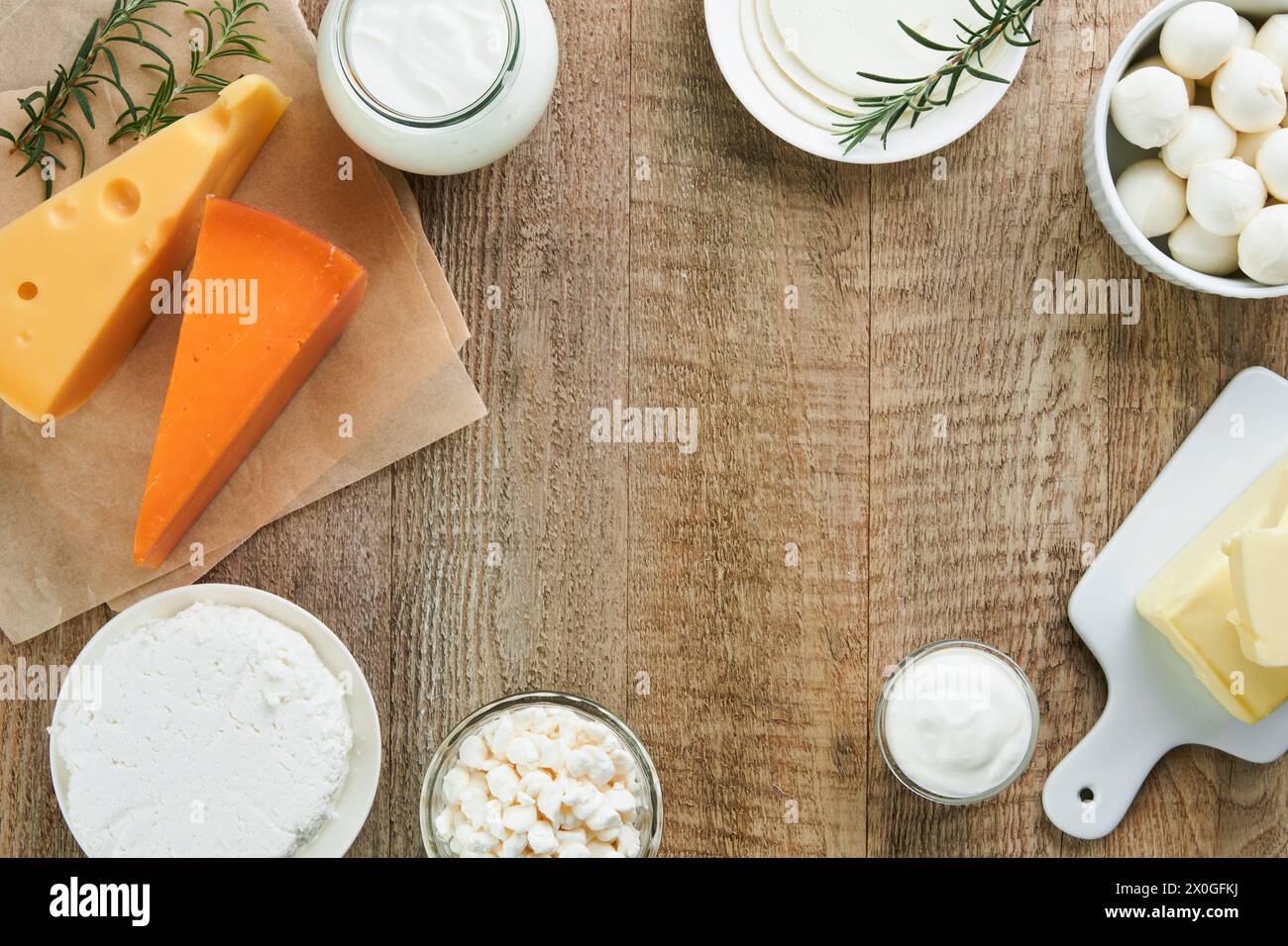 Dairy products or farm products. Fresh organic dairy products milk, cottage cheese, butter, cream, yogurt, sour cream and mozzarella on old wooden rus Stock Photo
