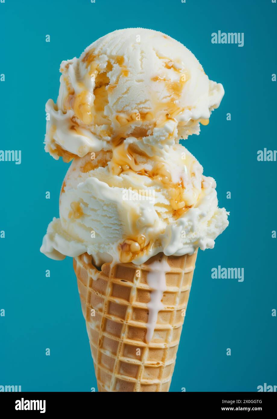Two scoops of Vanilla ice cream on top ice cream cone blue background ...