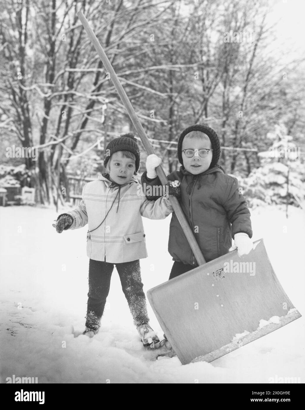 Children shovel snow Black and White Stock Photos & Images - Alamy