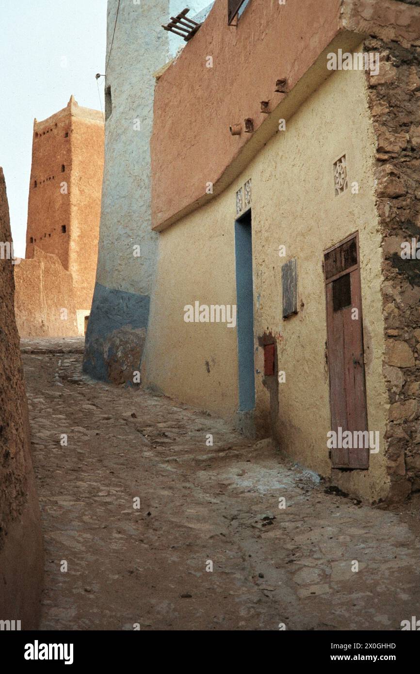 An old watchtower behind two apartment buildings at the end of an alley ...