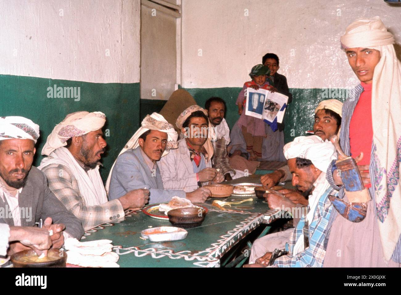 A group of Yemenis are having dinner at a restaurant in Amran. [automated translation] Stock Photo