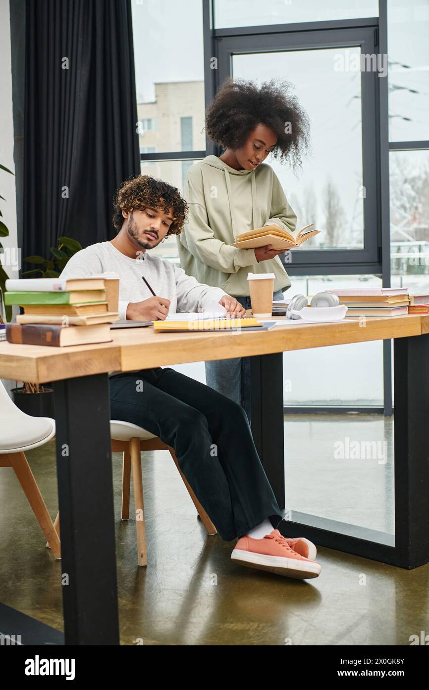 Two students from different cultural backgrounds sit at a table ...