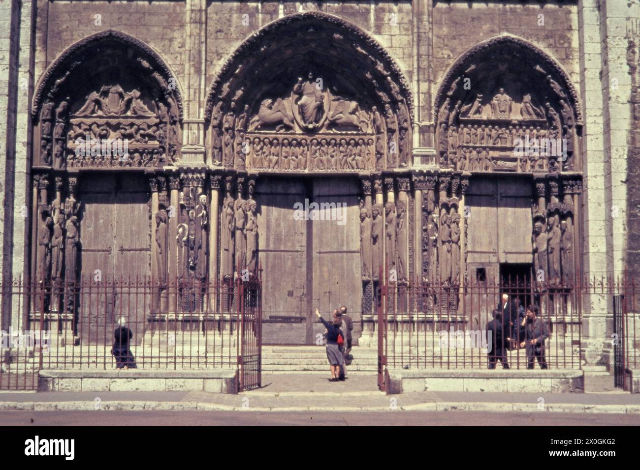Tourists in front of the main portal of Chartres Cathedral. [automated translation] Stock Photo