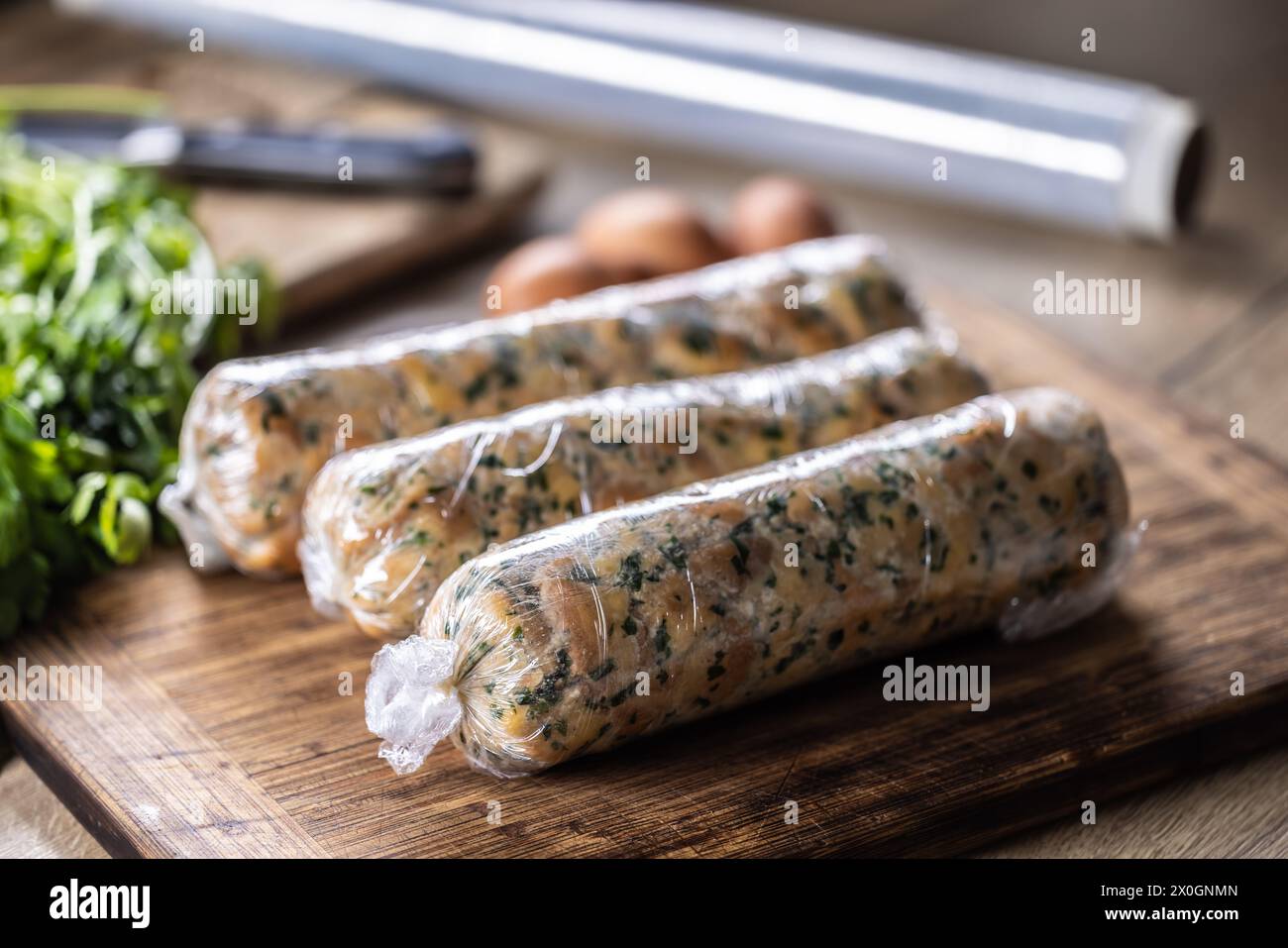 Preparation of Karlovy Vary dumplings wrapped in plastic foil. Traditional Czech dumpling. Stock Photo