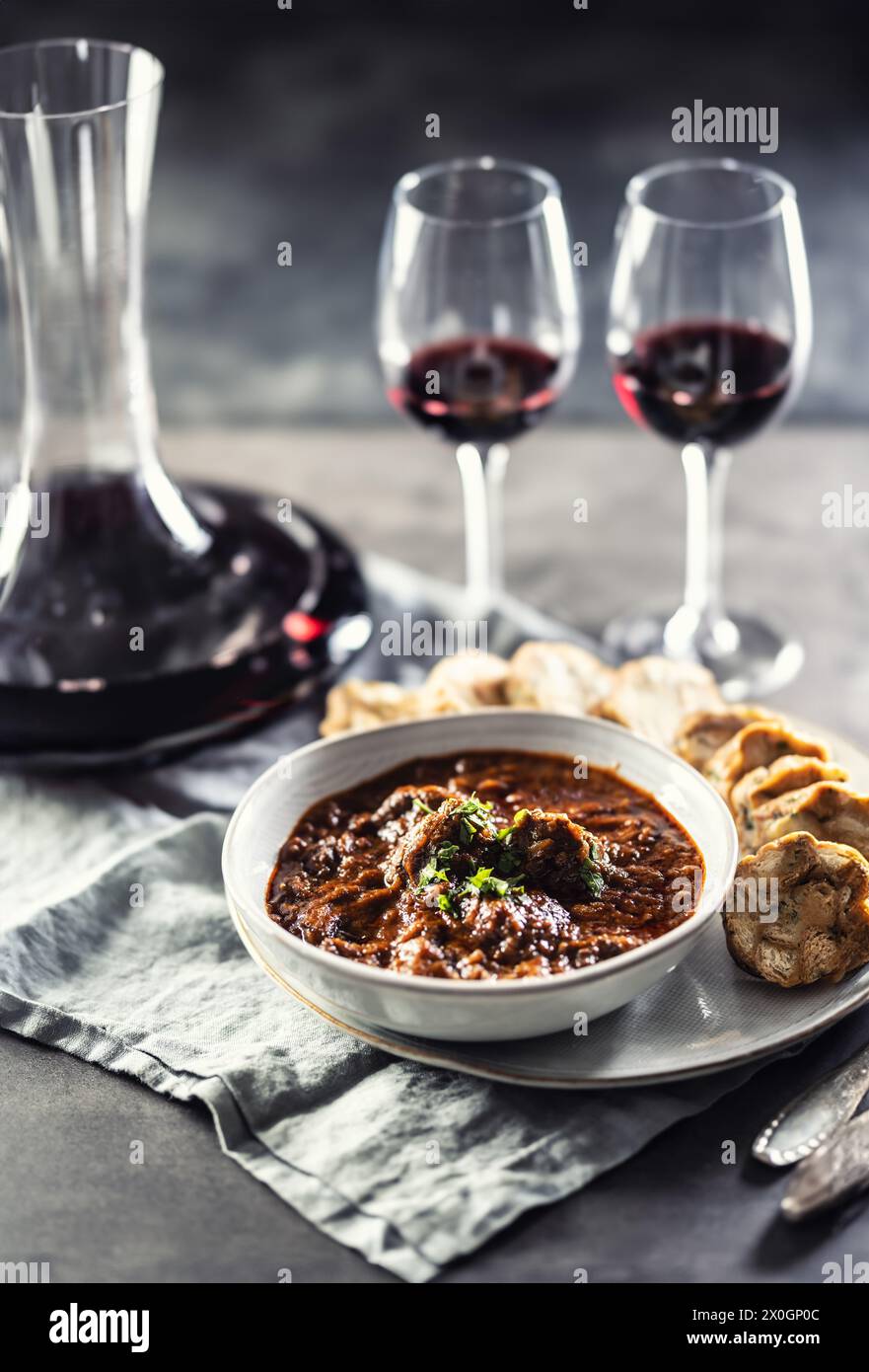 Traditional Viennese, venison or Hungarian goulash with Karlovy Vary dumplings and red wine. Stock Photo