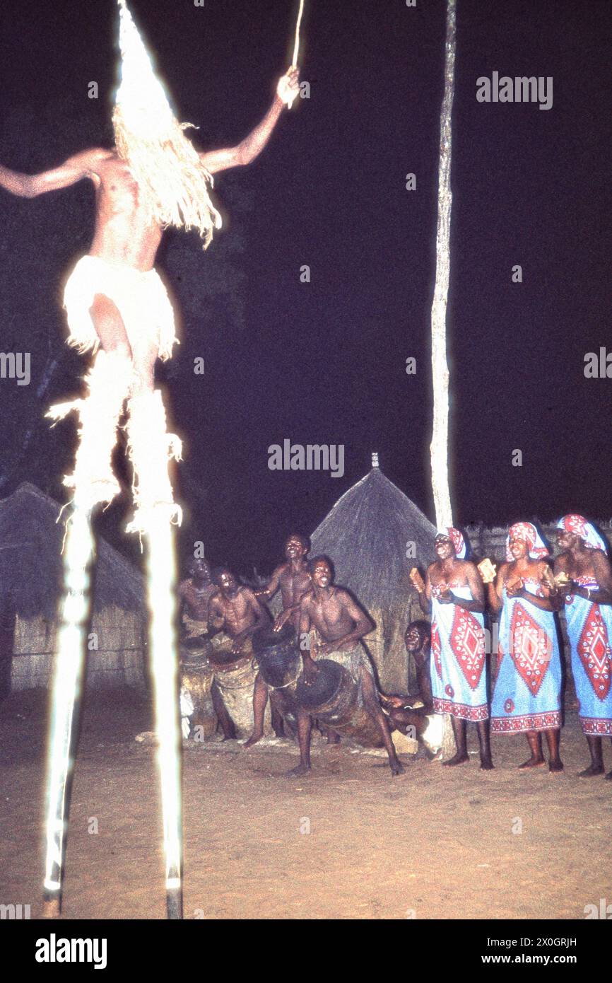 A costumed man on stilts from the Makishi ethnic group during a