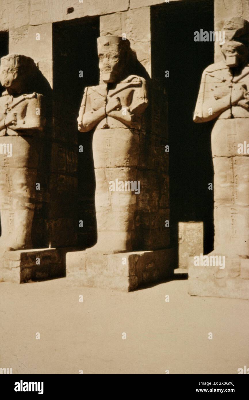 Statues of Osiris in front of the mortuary temple of Ramses III in ...