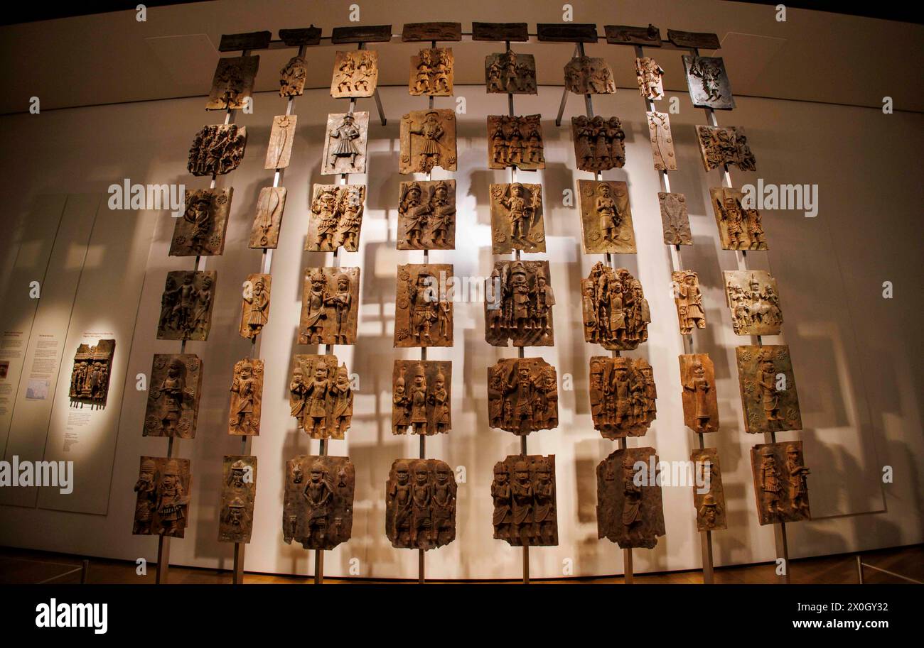 London, UK 12 April 2024 The Benin Bronzes in the Africa section at the British Museum. The Benin Bronzes are a group of thousands of objects including Cast Plaques, human and animal heads and figures that were taken from the kingdom of Benin, in what is now Nigeria, in 1897. The Bronzes were probably made between 1550-1650 by craftspeople working for the court of Oba the King. For many Nigerians, the Benin Bronzes are a potent reminder of colonialism and its continued effects on African society. Citizens in the country have long called for the return of the Benin Bronzes. Stock Photo