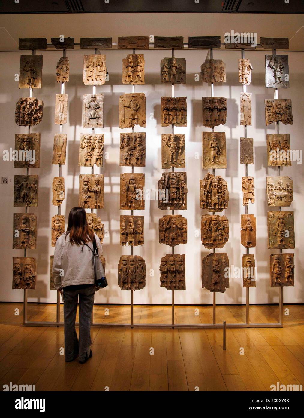 London, UK 12 April 2024 The Benin Bronzes in the Africa section at the British Museum. The Benin Bronzes are a group of thousands of objects including Cast Plaques, human and animal heads and figures that were taken from the kingdom of Benin, in what is now Nigeria, in 1897. The Bronzes were probably made between 1550-1650 by craftspeople working for the court of Oba the King. For many Nigerians, the Benin Bronzes are a potent reminder of colonialism and its continued effects on African society. Citizens in the country have long called for the return of the Benin Bronzes. Stock Photo