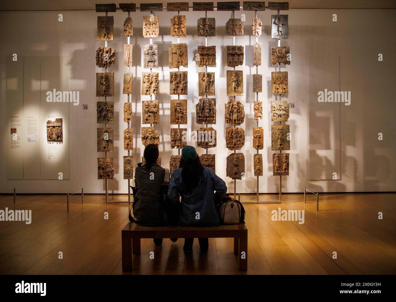 London, UK 12 April 2024 The Benin Bronzes in the Africa section at the British Museum. The Benin Bronzes are a group of thousands of objects including Cast Plaques, human and animal heads and figures that were taken from the kingdom of Benin, in what is now Nigeria, in 1897. The Bronzes were probably made between 1550-1650 by craftspeople working for the court of Oba the King. For many Nigerians, the Benin Bronzes are a potent reminder of colonialism and its continued effects on African society. Citizens in the country have long called for the return of the Benin Bronzes. Stock Photo