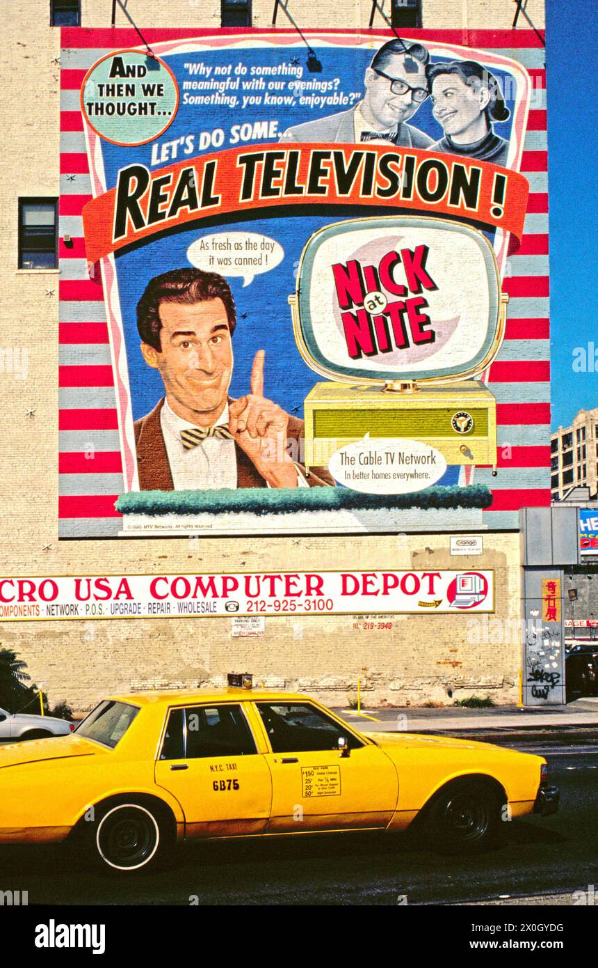 A Yellow Cab Taxi in SoHo in front of a TV billboard, New York 1992. [automated translation] Stock Photo