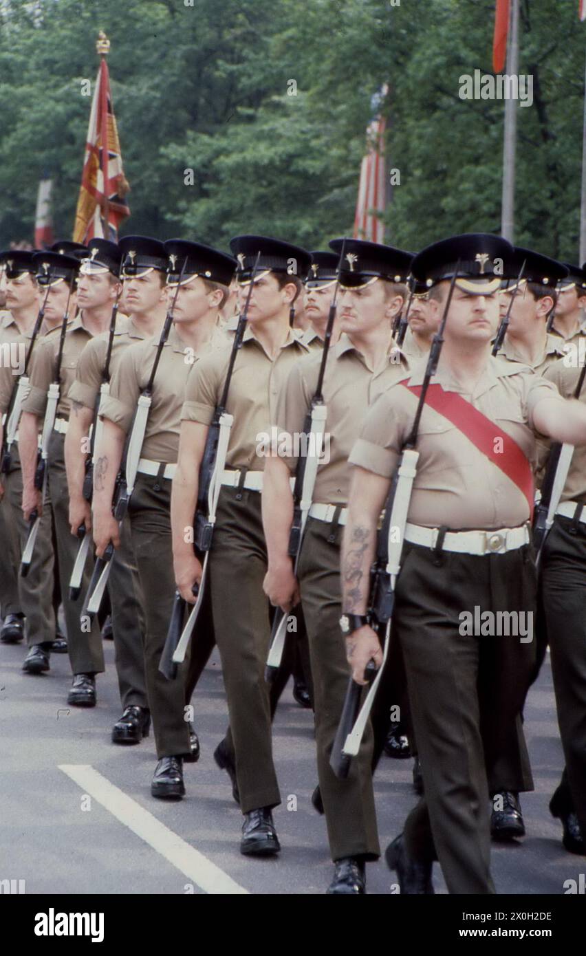 British soldiers with rifles march in lockstep at a military parade of the Allies in Berlin. Stock Photo