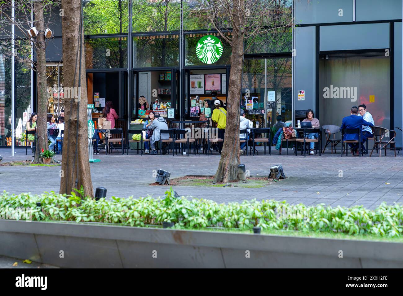 Taipei, Taiwan March 28 2024 People drinking coffee on Starbucks in Taipei Stock Photo