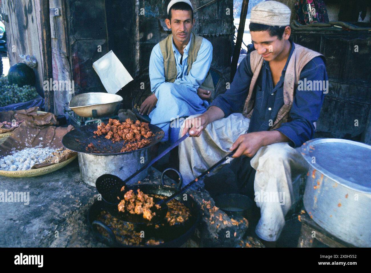 Two men prepare deep-fried sweets. [automated translation] Stock Photo ...