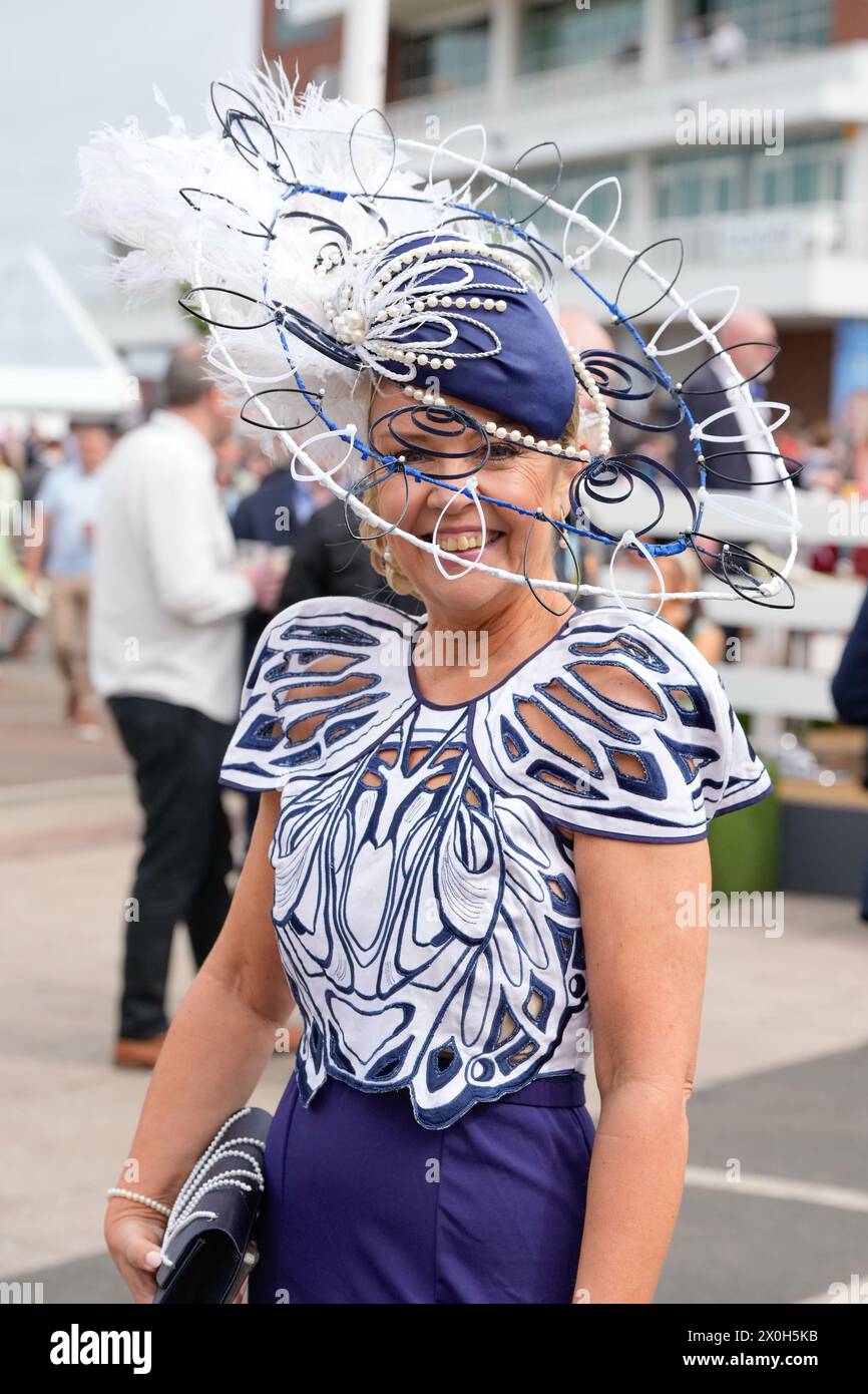 Aintree Racecourse, Aintree, Merseyside, England. 12th April 2024.  2024 Grand National Festival Day 2; A race goer wears a complex fascinator during Ladies Day, day 2 of the festival.Photo credit: Stephen Hearn/Action Plus Sports Images/ Alamy Live News Stock Photo
