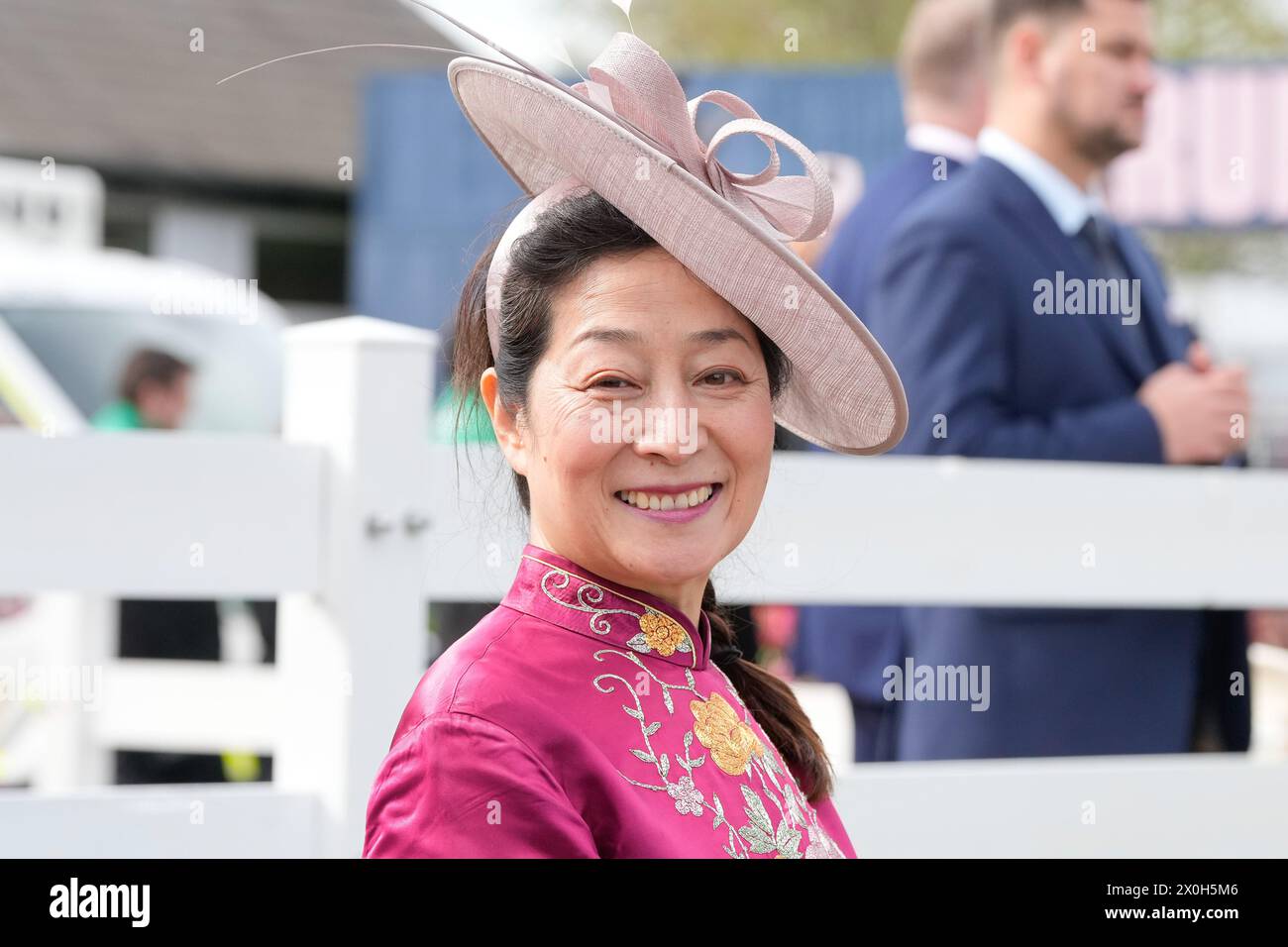 Aintree Racecourse, Aintree, Merseyside, England. 12th April 2024.  2024 Grand National Festival Day 2; A race goer poses for a photo during Ladies Day, day 2 of the festival.Photo credit: Stephen Hearn/Action Plus Sports Images/ Alamy Live News Stock Photo