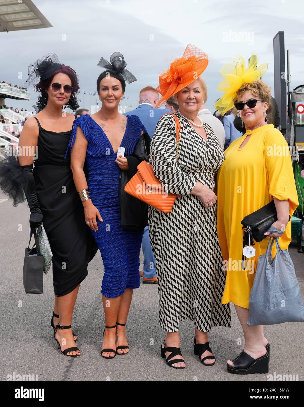 Aintree Racecourse, Aintree, Merseyside, England. 12th April 2024.  2024 Grand National Festival Day 2; Race goers pose for photos during Ladies Day, day 2 of the festival.Photo credit: Stephen Hearn/Action Plus Sports Images/ Alamy Live News Stock Photo