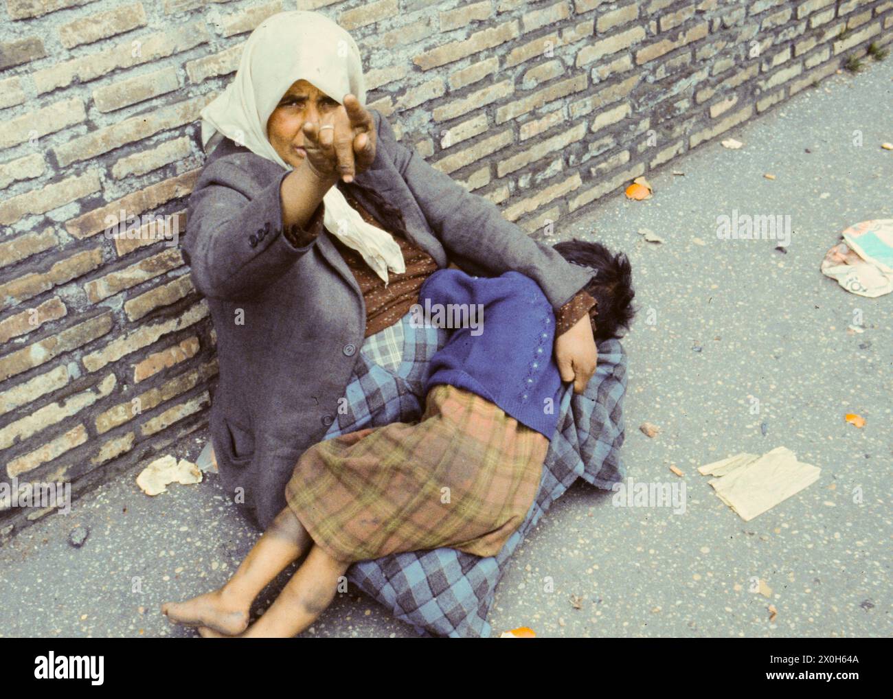 'The beggar woman shows the ''mano cornuta'' as an expression of her displeasure [automated translation]' Stock Photo
