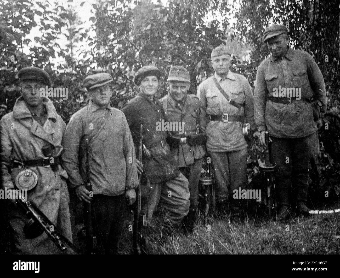 Group photo of Russian auxiliary troops fighting partisans with a Wehrmacht soldier. The picture was taken by a member of the Radfahrgrenadierregiment 2 / Radfahrsicherungsregiment 2, on the Eastern Front. [automated translation] Stock Photo