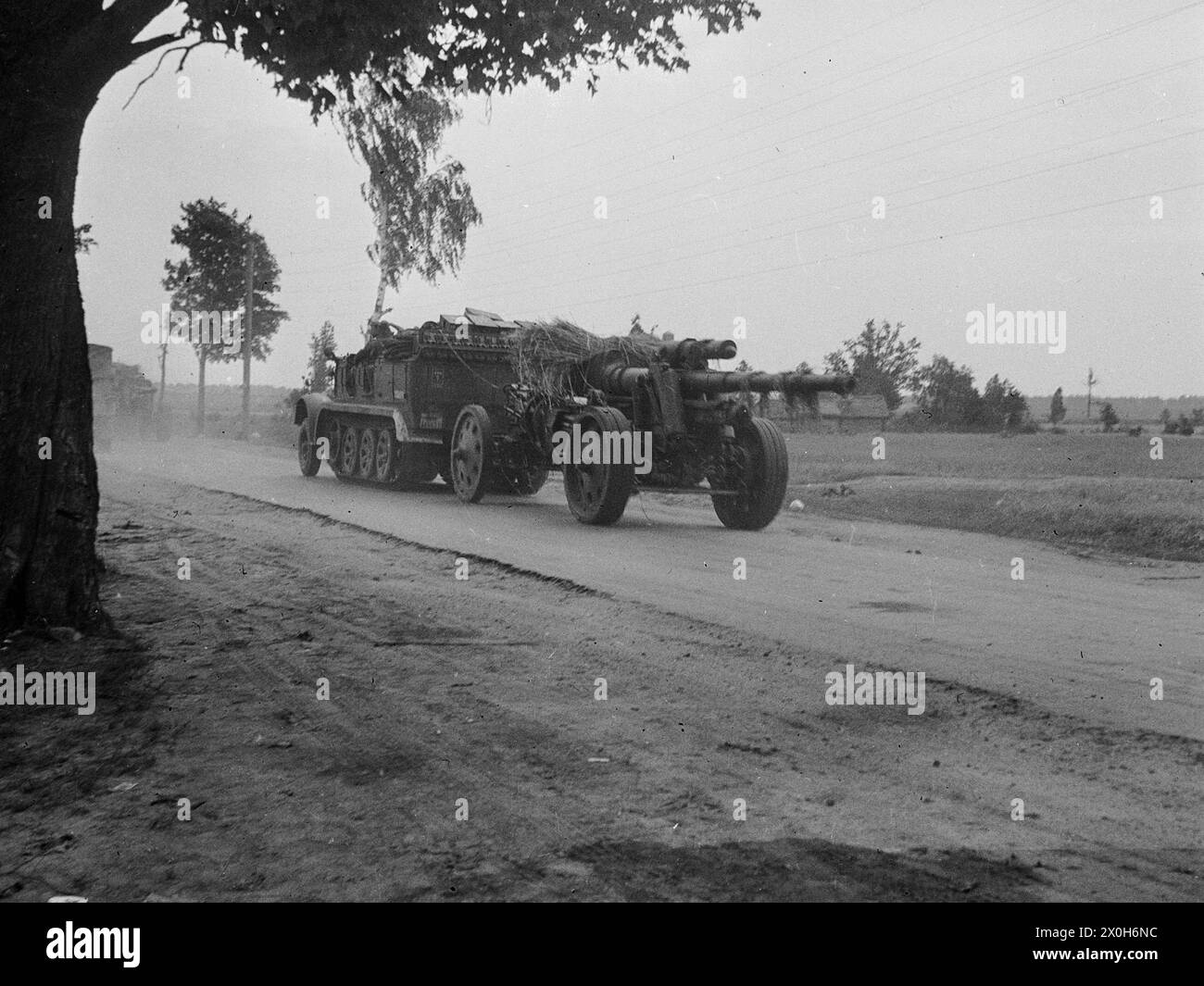 A 15cm field howitzer 18 is towed by a half-track vehicle in France. The picture was taken by a member of the 154th Infantry Regiment / 58th Infantry Division, in France. [automated translation] Stock Photo
