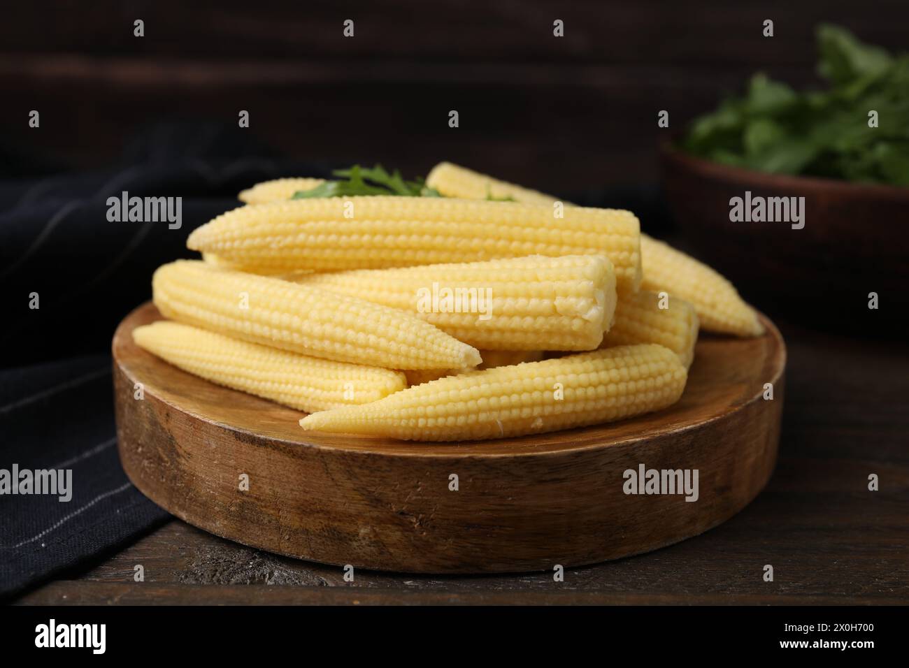 Tasty fresh yellow baby corns on wooden table Stock Photo