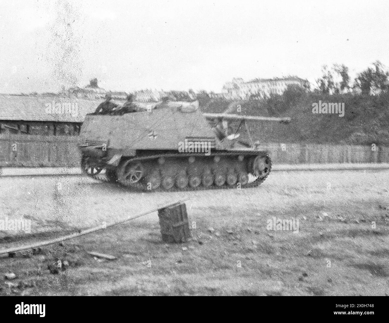 A German tank destroyer Nashorn drives through a town on the Eastern Front. The picture was taken in the rear of the Eastern Front, presumably in connection with battles with partisans. The picture was taken by a member of the Radfahrgrenadierregiment 2 in the northern section of the Eastern Front. [automated translation] Stock Photo