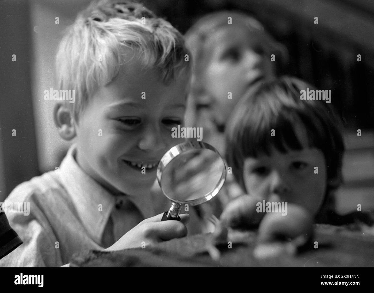 The little explorer has discovered something funny with the magnifying