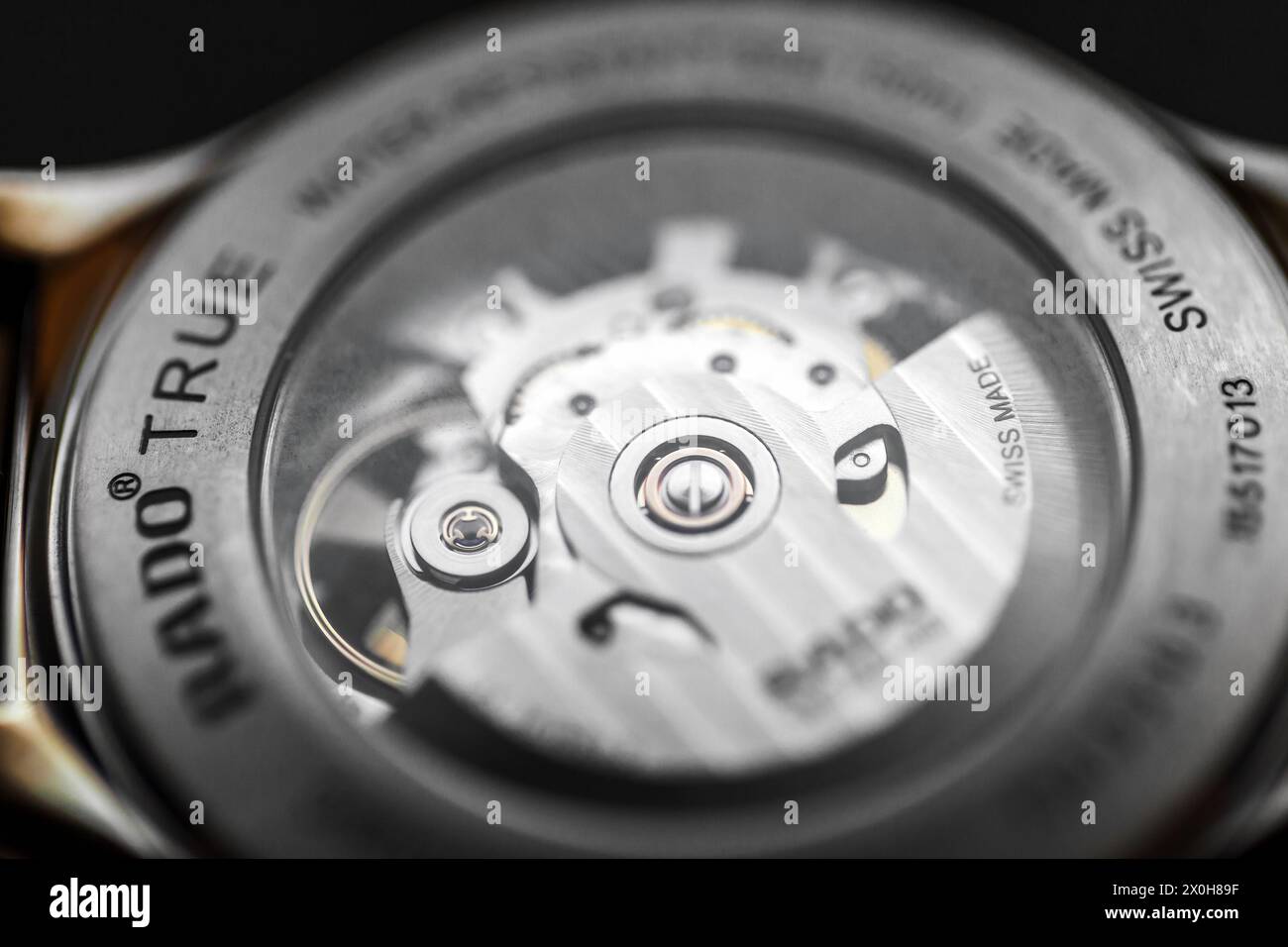 Lengnau, Switzerland - November 11, 2021: Watch movement is behind transparent back case of Swiss made self-winding mechanic wrist watch Rado Automati Stock Photo