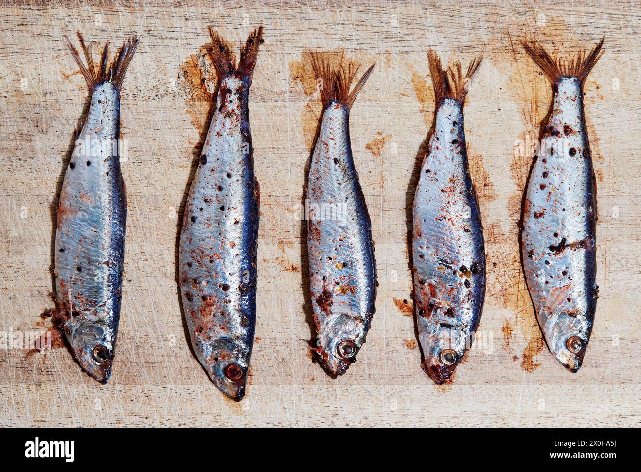 Ansjovis, Swedish anchovies (i.e. sprats) on a wooden board Stock Photo