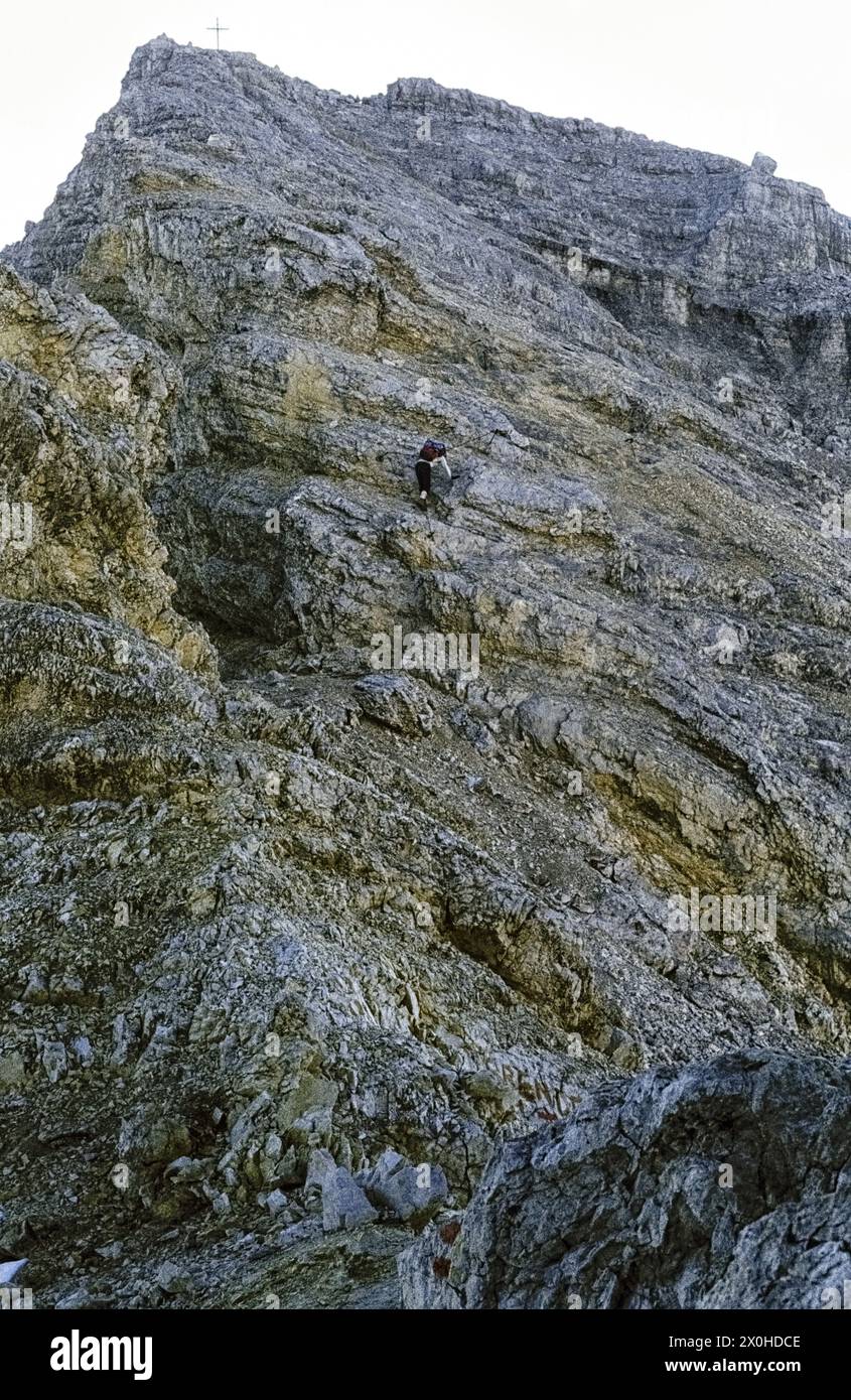 A hiker on the steep, rope-insured path shortly before the summit [automated translation] Stock Photo