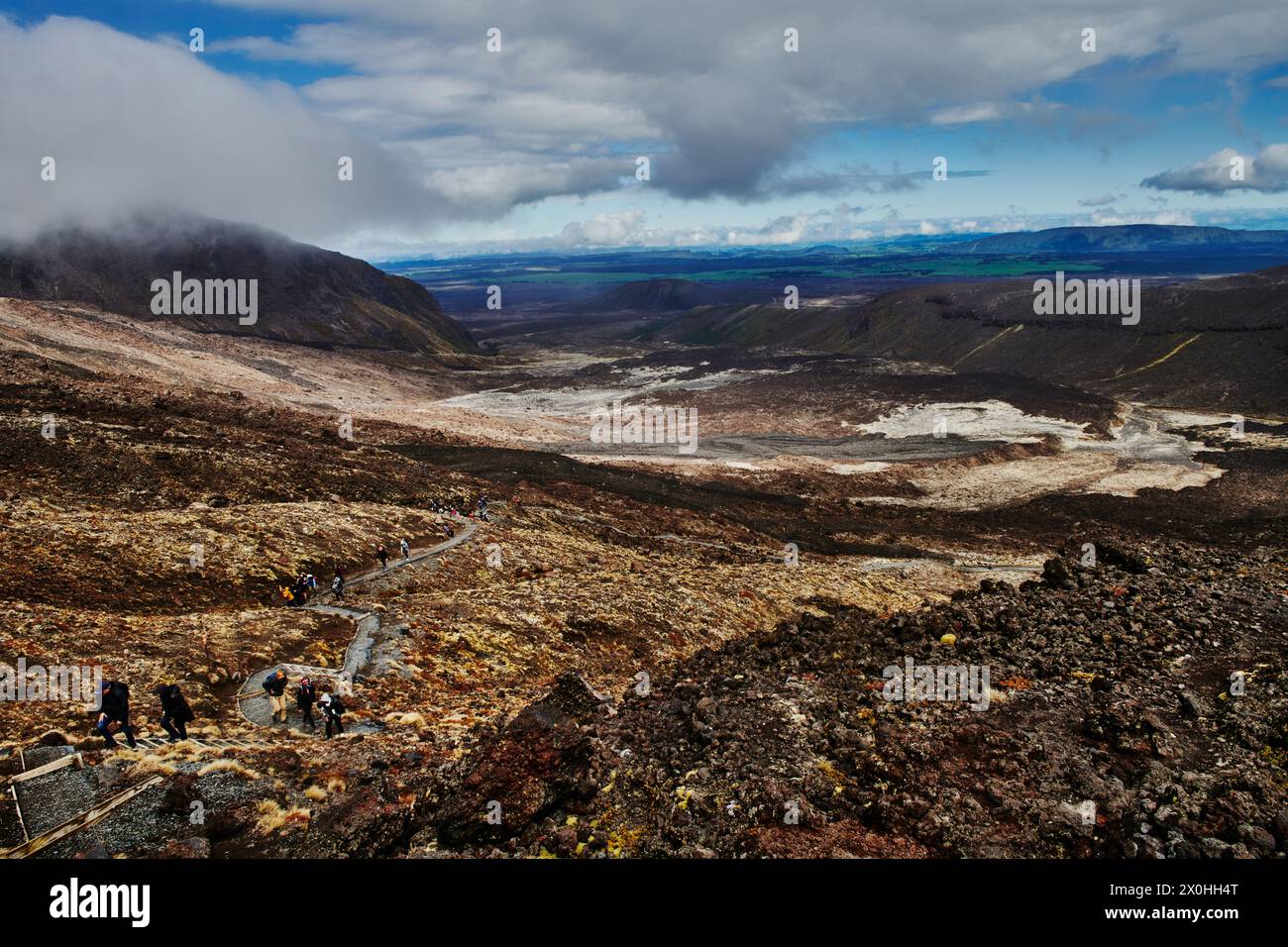 Hikers along Tongariro Alpine Crossing trail, Tongariro National Park, North Island, New Zealand Stock Photo