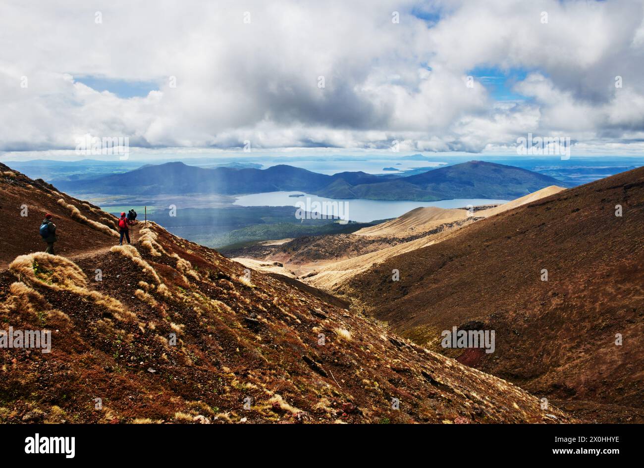 Hikers along Tongariro Alpine Crossing trail, Tongariro National Park, North Island, New Zealand Stock Photo