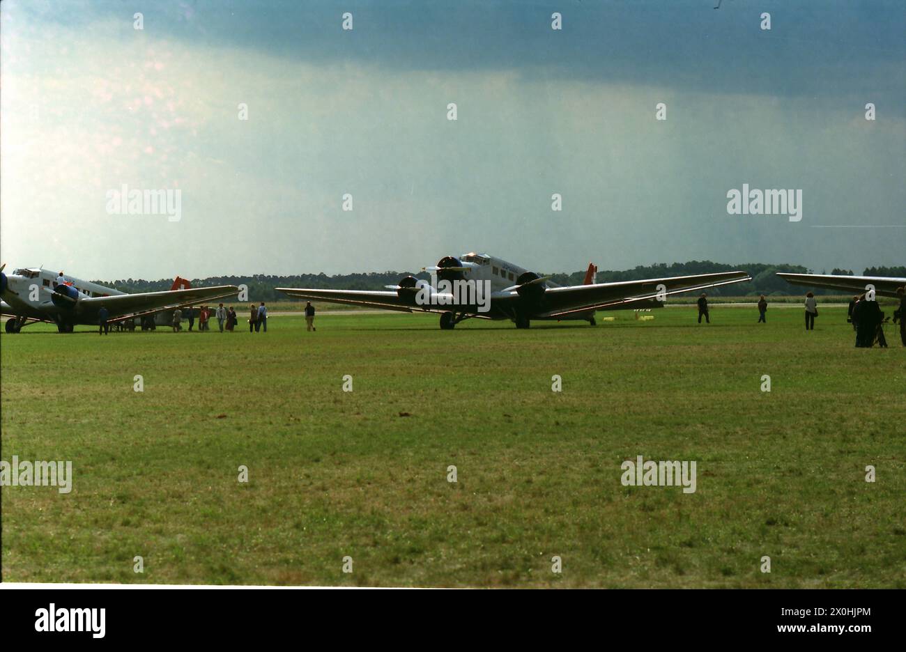 In the summer of 1994, the old Junkers factory airfield was (re)opened for civil aviation after having been used largely for military purposes. It was a moving experience to see 4 JU 52s (three Swiss and the one from Lufthansa) flying in formation and low over the airfield. [automated translation] Stock Photo