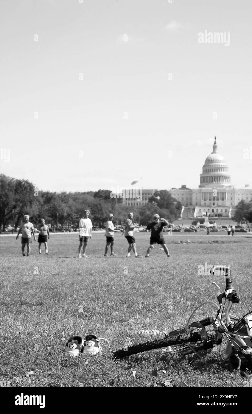 Young men play Frisbee in front of Capitol in Washington DC USA Stock Photo