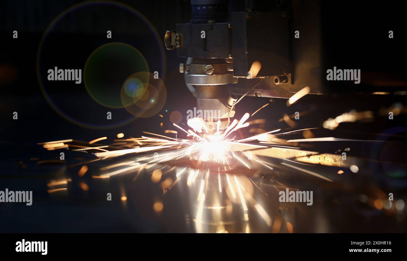 Sparks fly out machine head for metal processing Stock Photo