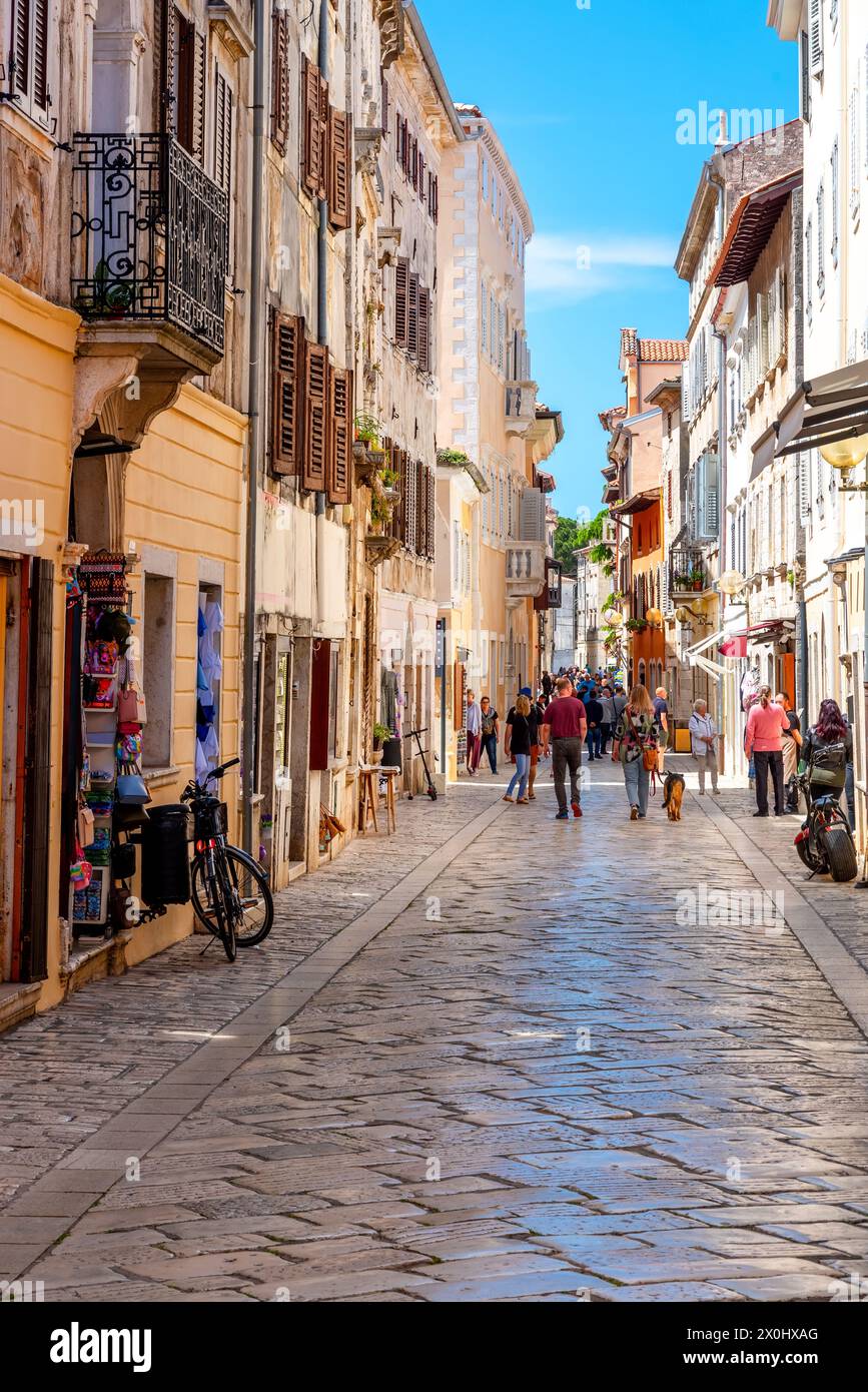 People walk the old town streets in Porec, Croatia Stock Photo