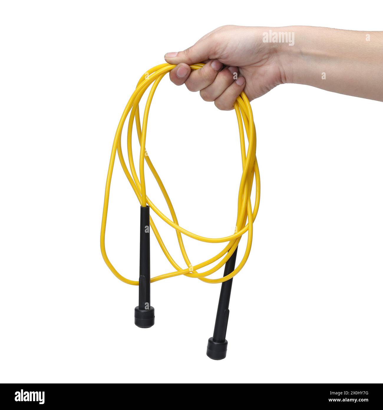 yellow black skipping rope hold in hand isolated on white background Stock Photo