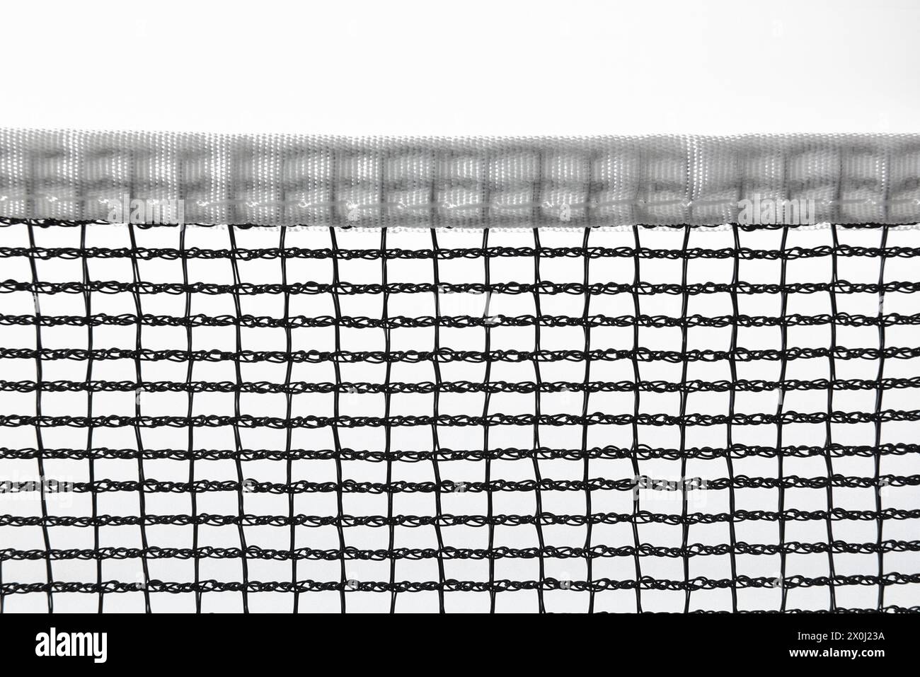 Black sports net with white border for racket and ball games isolated on white background. Stock Photo