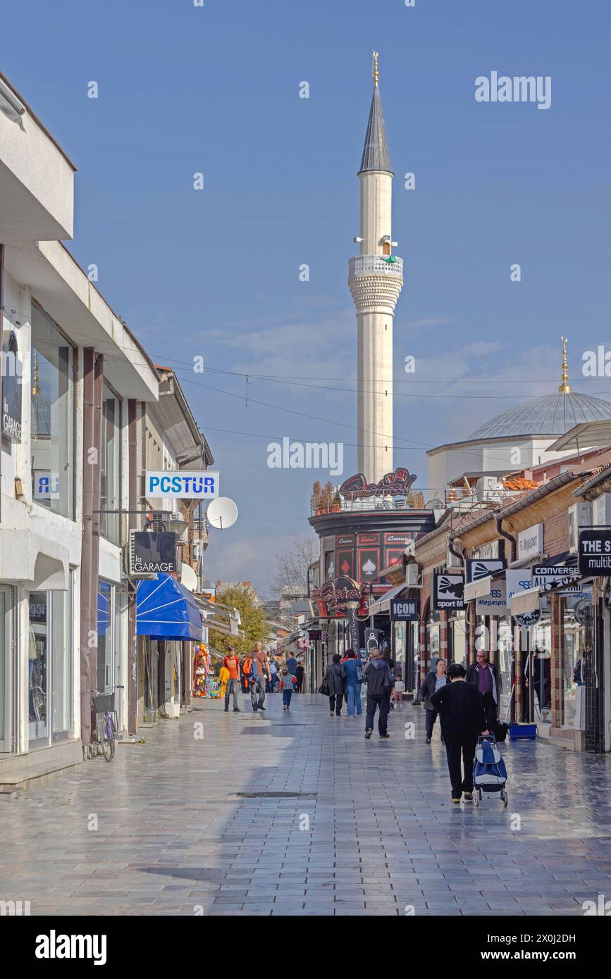 Ohrid, North Macedonia - October 23, 2023: People Walking at St Clement Street in Old Town Sunny Autumn Day and White Minaret at Mosque. Stock Photo