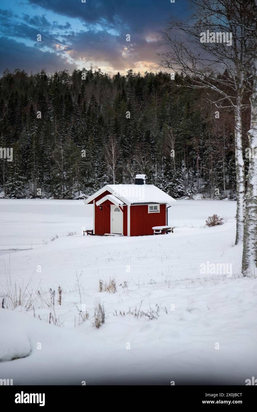 Red house by a snowy forest hi-res stock photography and images - Alamy