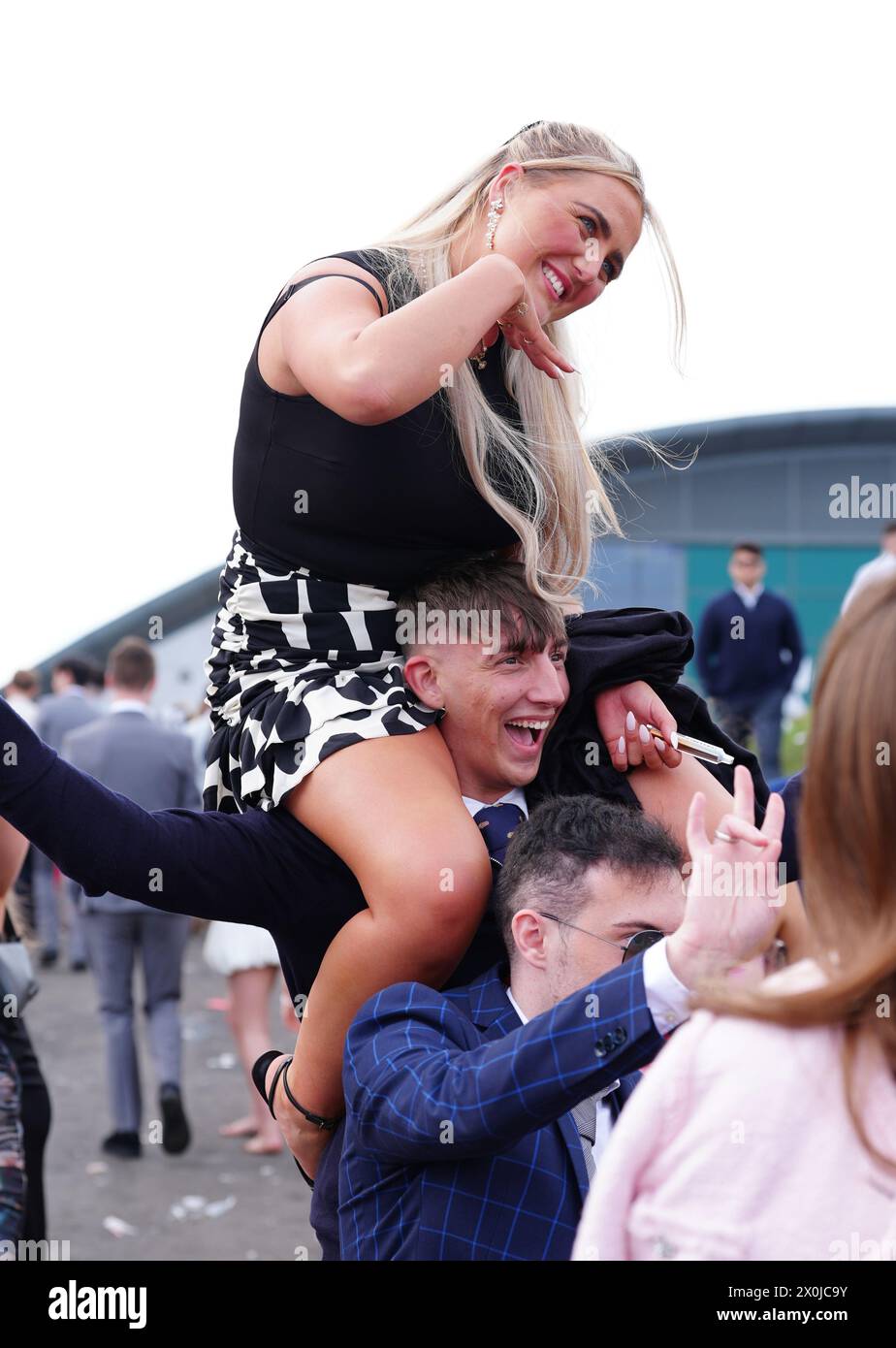 Racegoers in good spirits on day two of the 2024 Randox Grand National Festival at Aintree Racecourse, Liverpool. Picture date: Friday April 12, 2024. Stock Photo