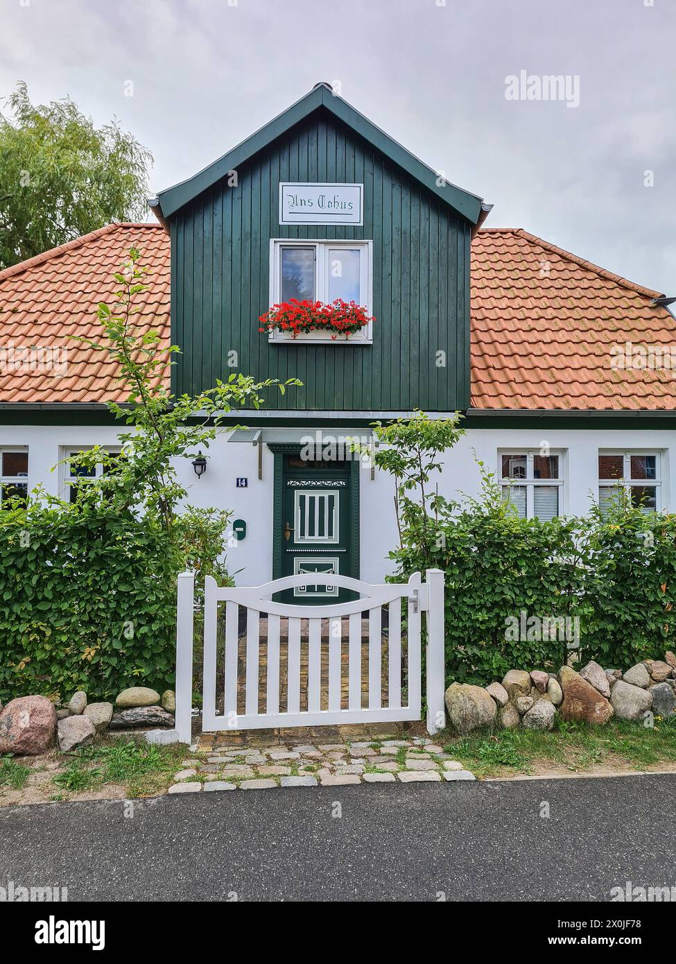 View from the public street of a traditional Nordic house with wooden facade in the vacation resort and Baltic Sea resort of Prerow, Fischland Darß, Mecklenburg-Vorpommern, Germany Stock Photo