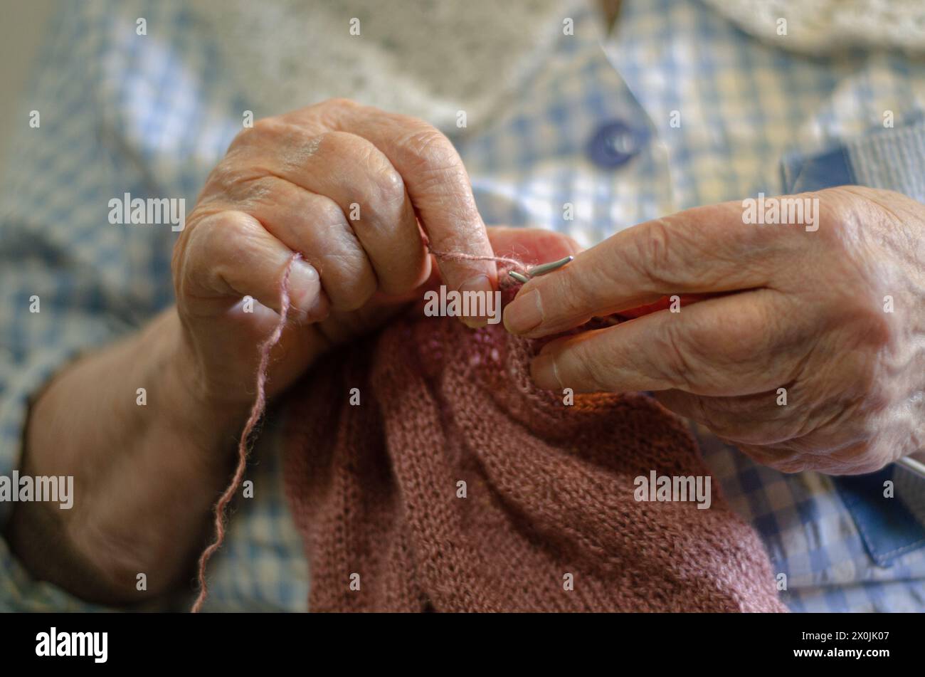 Old woman knitting at home Stock Photo