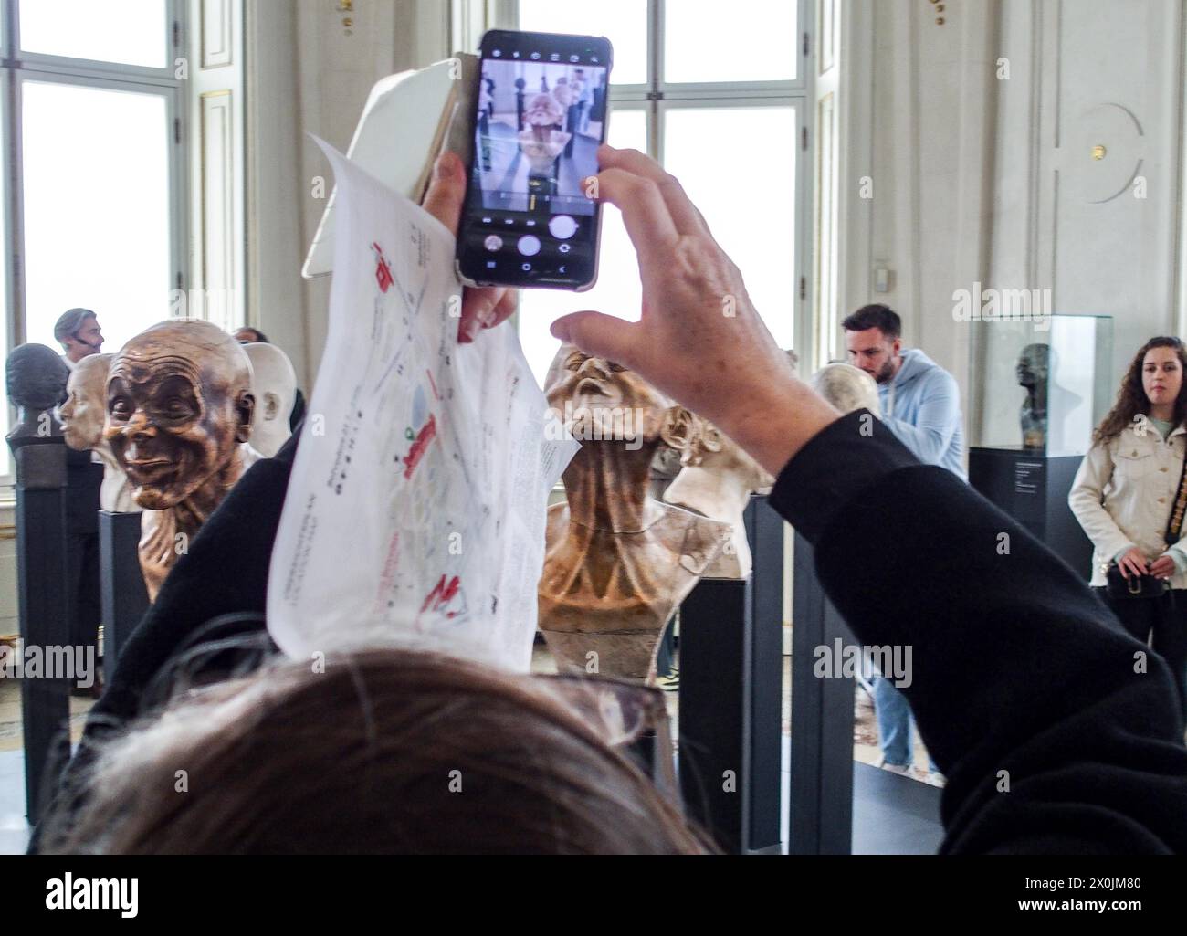 Vienna, Austria, Austria. 12th Apr, 2024. Tourists take a photo of the character heads of FRANZ XAVER MESSERSCHMIDT, inside the Upper Belvedere Palace in Vienna. The Upper Belvedere palace is one of the world's first public museums, opening in 1777. It houses some of the most coveted artwork and most diversified collections in Europe. (Credit Image: © Bianca Otero/ZUMA Press Wire) EDITORIAL USAGE ONLY! Not for Commercial USAGE! Stock Photo